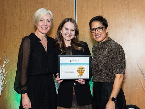 Three women smiling during an ambassador recognition event in Québec City. One of them holds a certificate.